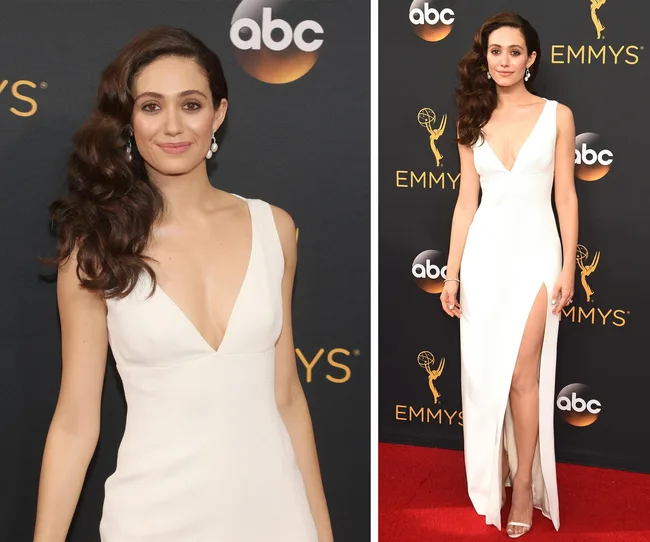 Woman in a white dress poses on the red carpet at the Emmys, with ABC logo in the background.