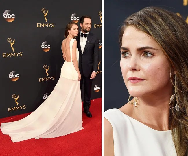 A woman in a white gown and a man in a tuxedo on the Emmys red carpet; close-up of the woman's face on the right.