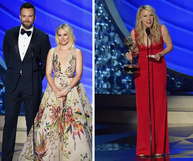 Presenters in formal attire on stage with blue backdrop; woman in red dress holds Emmy award.