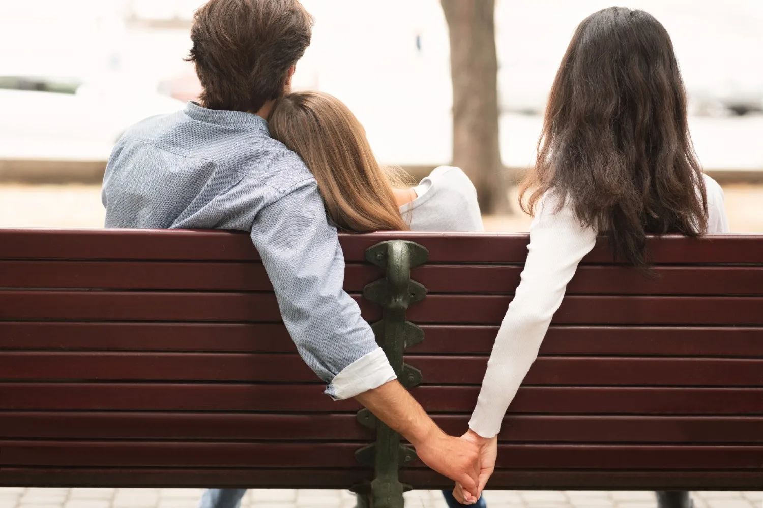 woman and man hold husband on bench