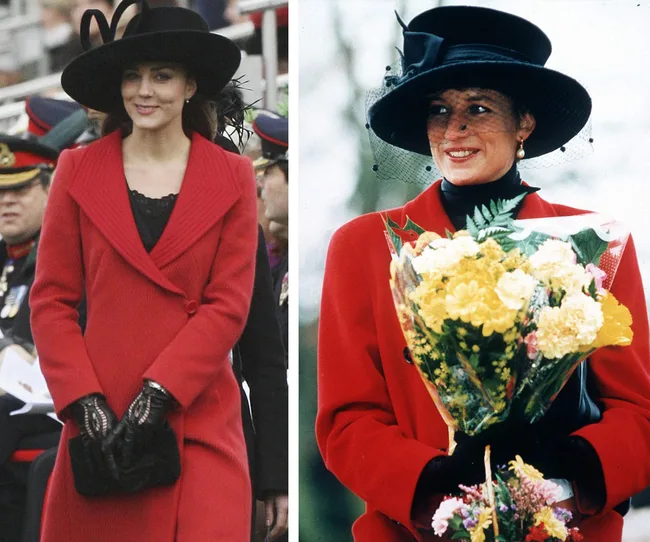 Two women in red coats and black hats; one holds a flower bouquet.