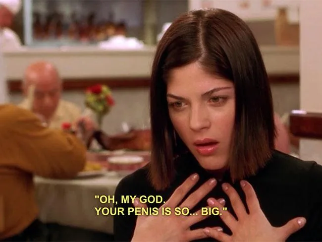Young woman in a restaurant with hands on chest, surprised expression, caption reads, "Oh, my God. Your penis is so... big."