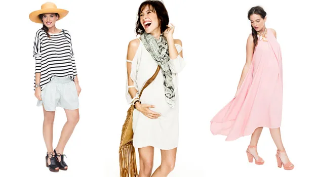 Three women in maternity outfits: a striped top with shorts, a white dress with scarf, and a flowing pink dress.