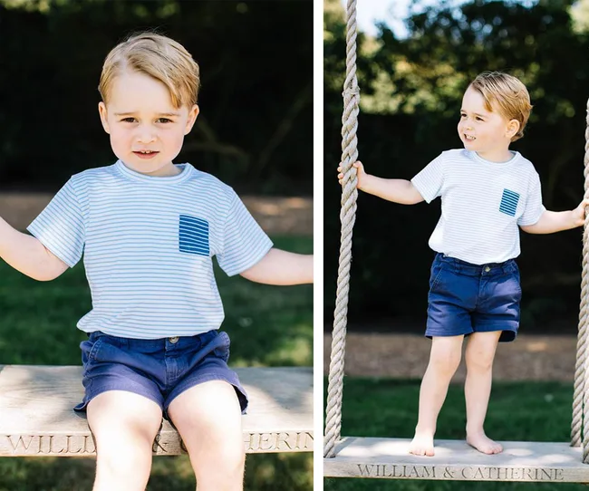 Young child with blond hair in blue striped shirt and shorts, sitting and standing on a swing in a garden.