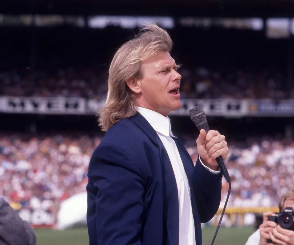 A young John Farnham performing at the AFL Grand Final in 1989