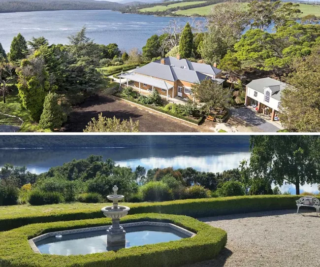 Aerial view of a countryside house by a lake, surrounded by trees. Front view of a fountain and landscaped garden.