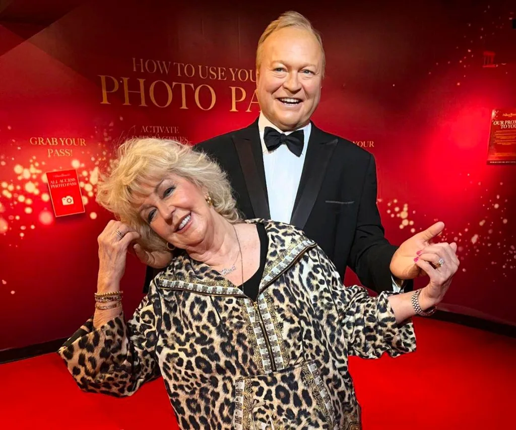 Patti Newton posing with her late husband Bert Newton's wax figure.