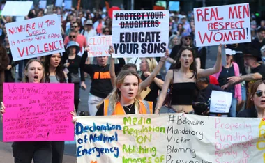 Australians protest domestic violence, carrying signs Real Men Respect Women, etc