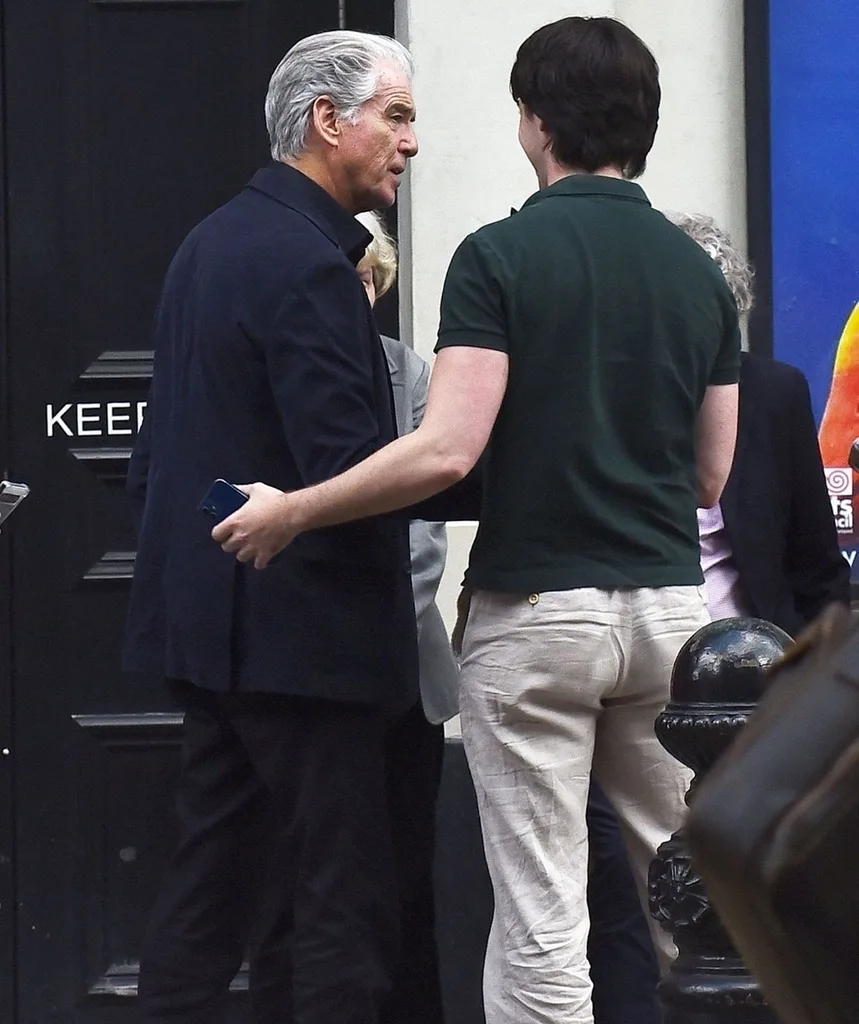 Pierce Brosnan son faces away fromt he camera talking to his dad