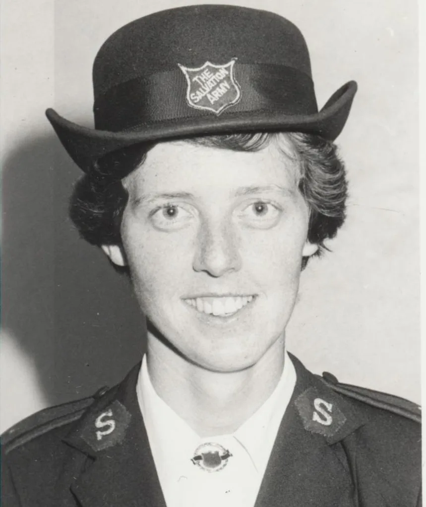 An early, black and white, photo of Miriam, smiling in her Salvos uniform