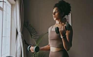 woman doing dumbbell bicep workout at home