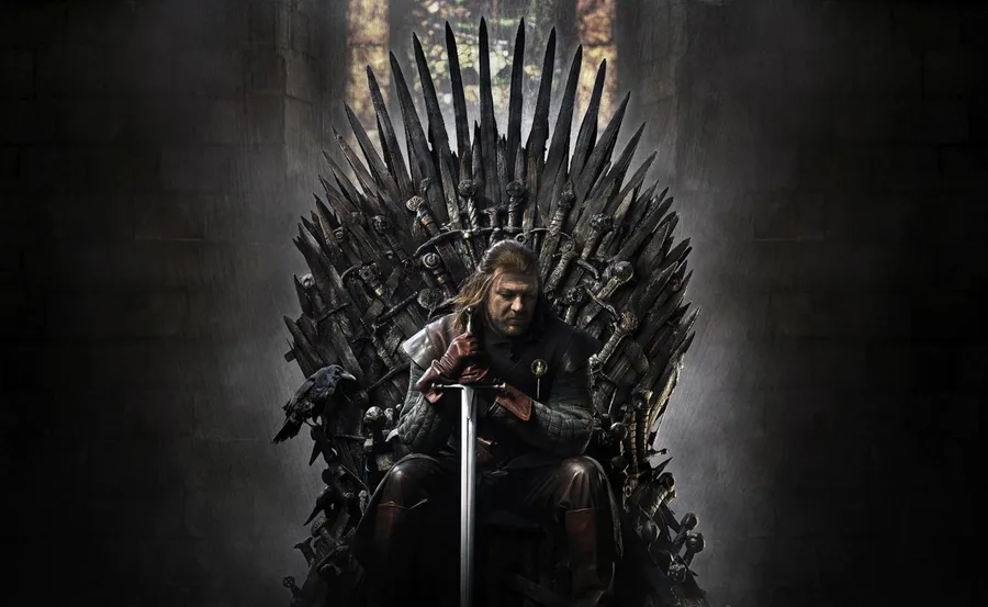 Game of Thrones star sits on Iron Throne holding sword, tip down to the floor