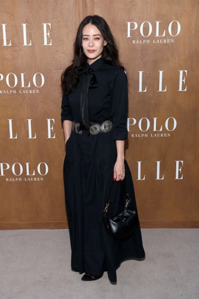 Highdee Kuan wearing a long black shirt dress and black cowgirl inspired waist belt at a Polo Ralph Lauren launch.