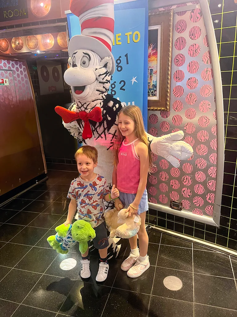 kids posing for a pic with a Dr Seuss character on a cruise 