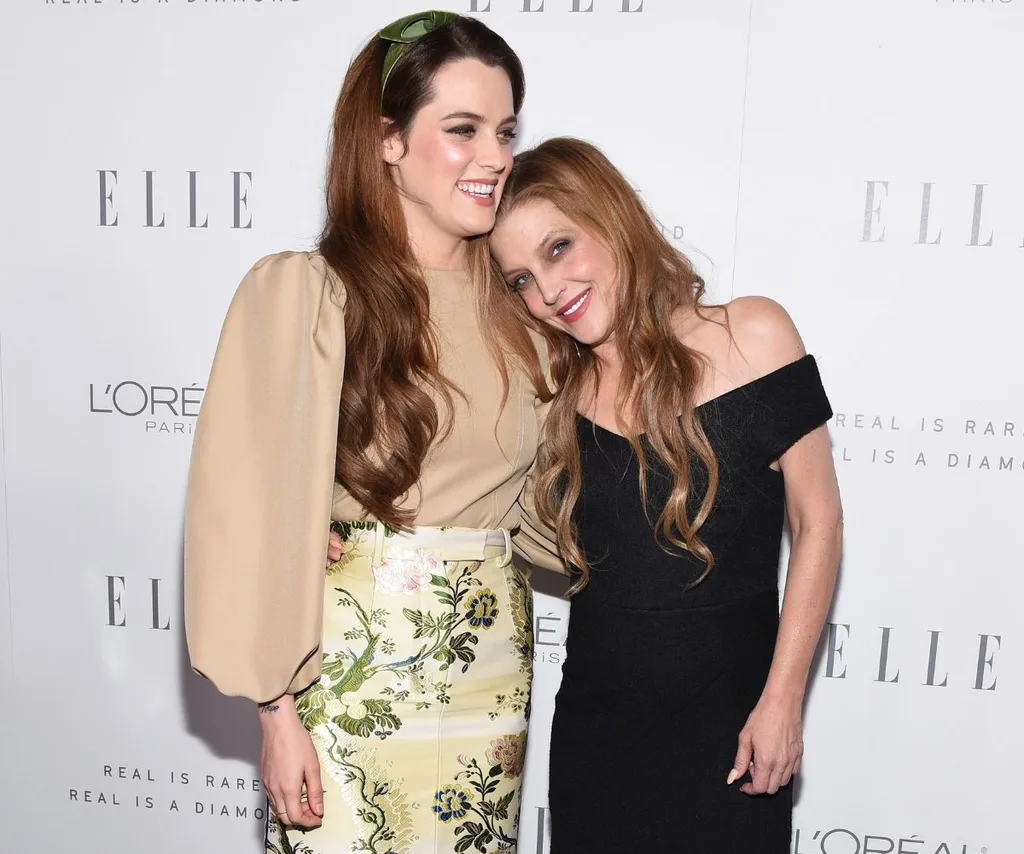 Lisa Marie Presley smiling hugging her daughter Riley Keough.