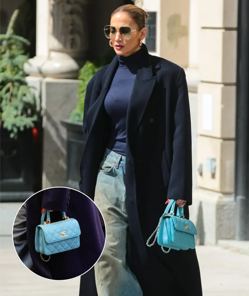 Jennifer Lopez wears a long trench coat and sports a teal chanel bag