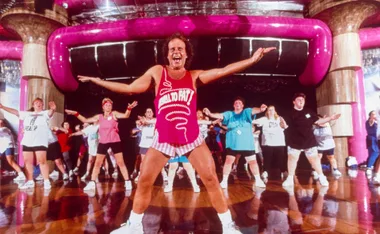 Richard Simmons leading a class in hot pink top and white tiny shorts
