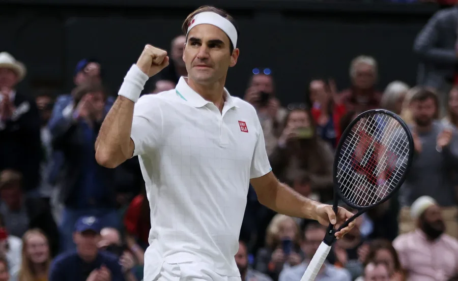 Roger Federer in tennis gear making a triumphant fist