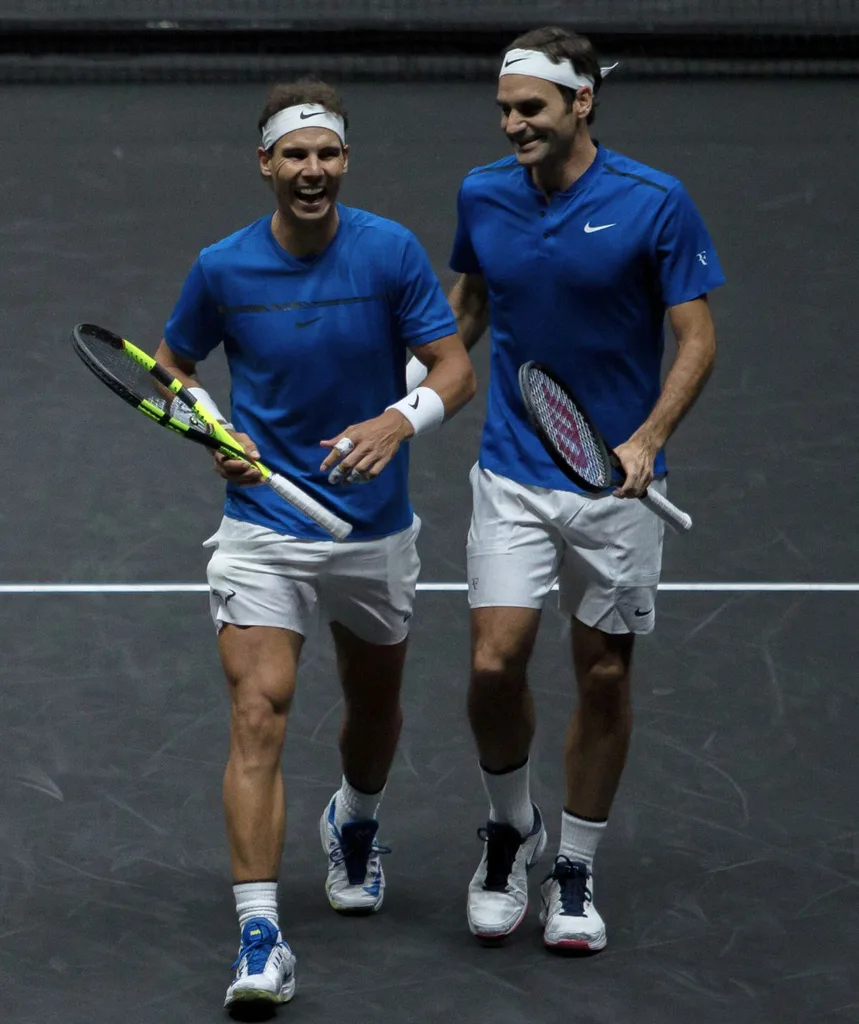 Roger and Rafa on the tennis court, looking friendly, smiling