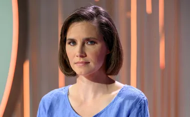 amanda knox looks upset-ish in a blue top