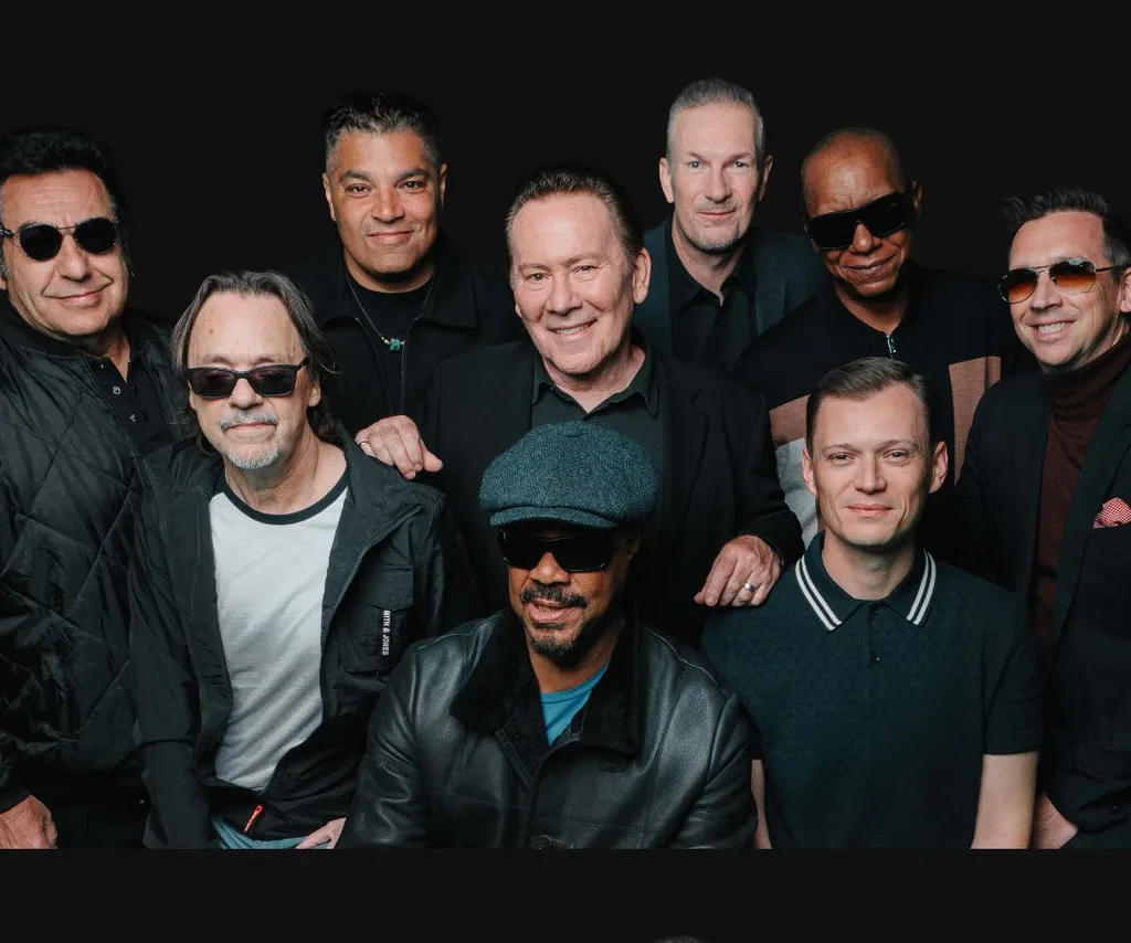 UB40 band pose for photo wearing mostly black