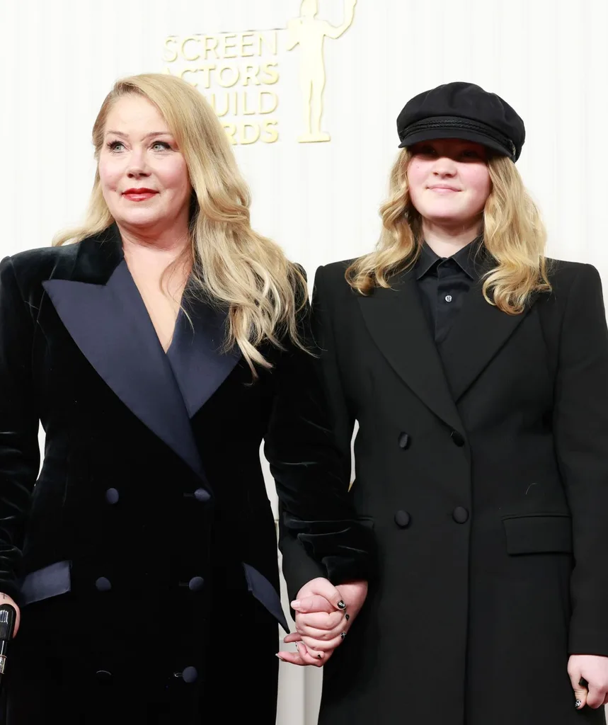 Christina Applegate and daughter Sadie hold hands wearing black suits