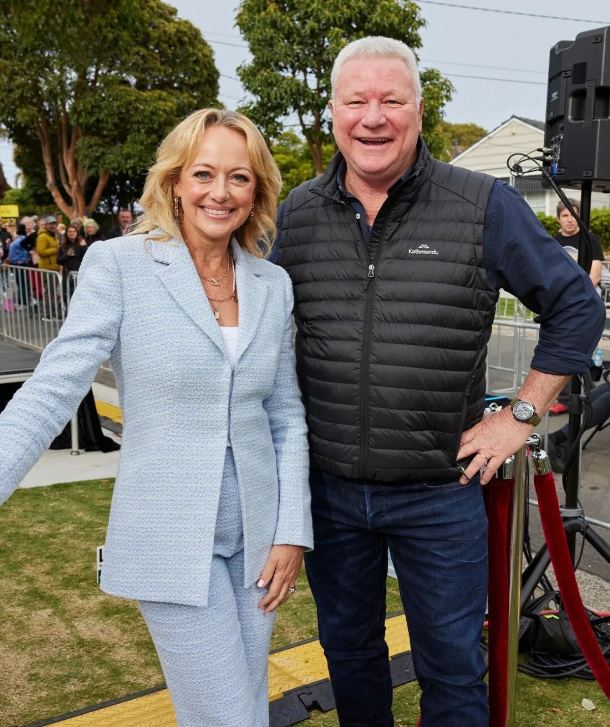 Shelly Craft wears a blue suit with a casual dressed Scotty Cam for the 2023 auction.