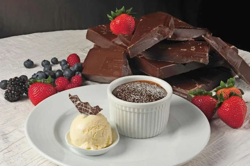 warm chocolate melting cake with chocolate pieces and strawberries