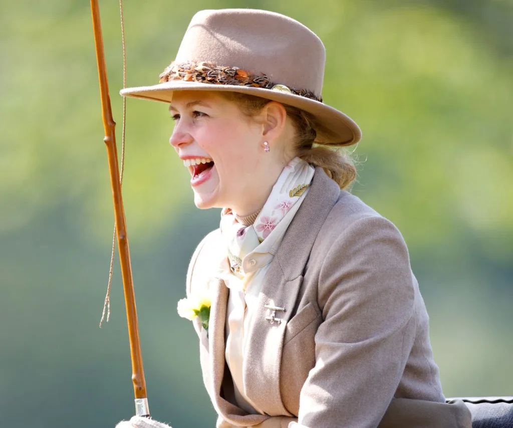 Lady Louise Windsor riding a horse and smiling.