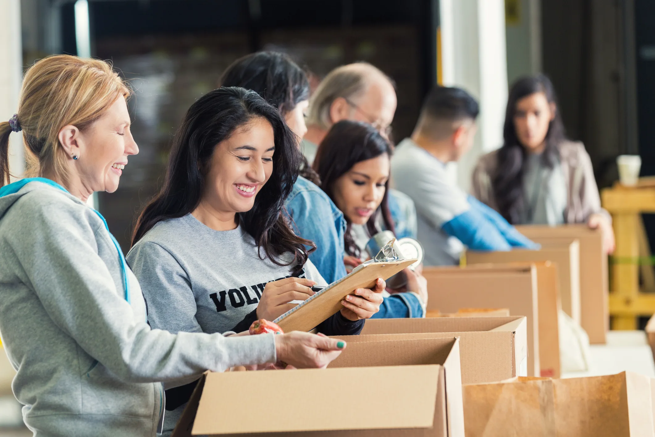 women volunteering packing boxes