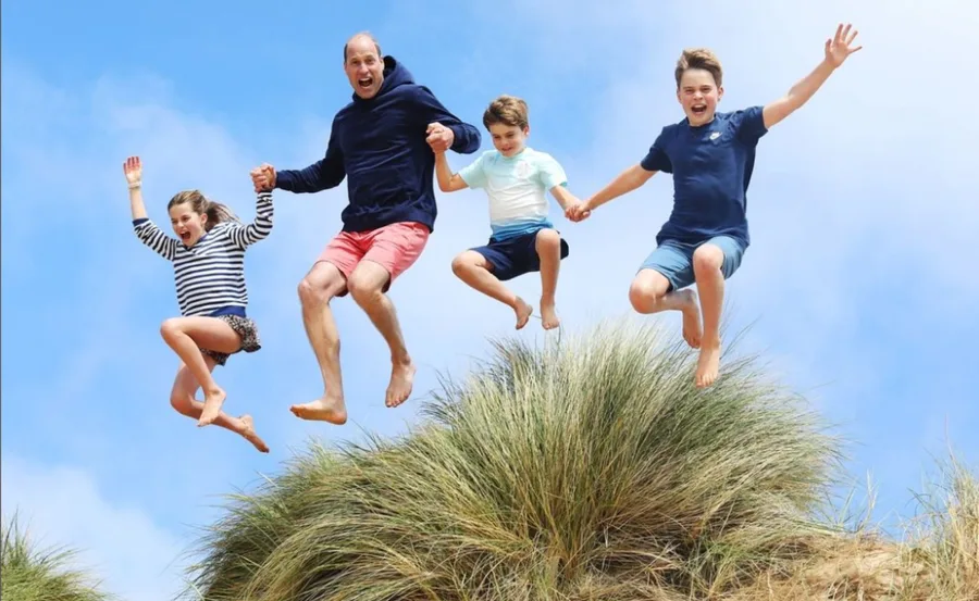 prince william and children jumping holding hands