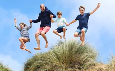 prince william and children jumping holding hands