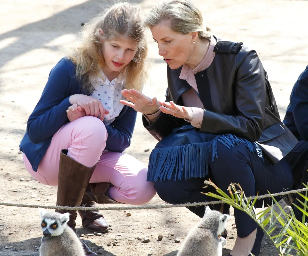 Sophie, Duchess of Edinburgh and Lady Louise crouch down by lemurs at the zoo