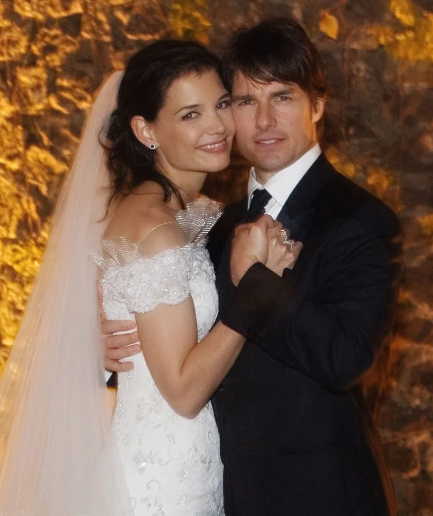 Katie Holmes and Tom Cruise in wedding dress and tux smile at their wedding