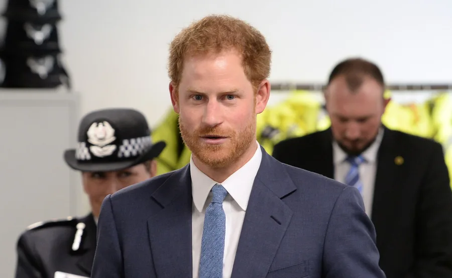 Harry wearing suit looking at camera