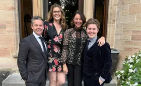 Todd Woodbridge poses with family dressed nicely outdoors