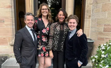 Todd Woodbridge poses with family dressed nicely outdoors