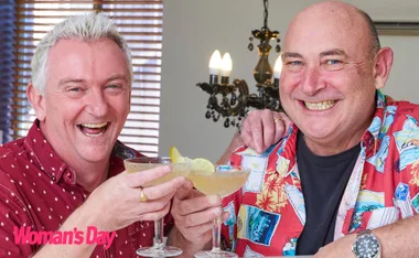 Travel Guides Matt and Brett smile, cheersing their martinis