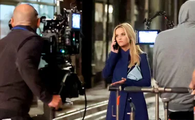Reese Witherspoon looks upset on the phone filming for Morning Wars