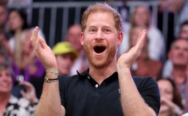 Prince Harry is very happy, clapping mouth open, likely because he's set to inherit millions from Queen Mother