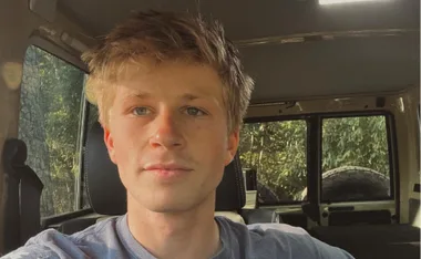 robert irwin stares into the distance in a truck