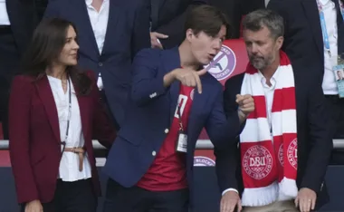 Prince Christian with parents at a sporting event
