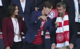 Prince Christian with parents at a sporting event