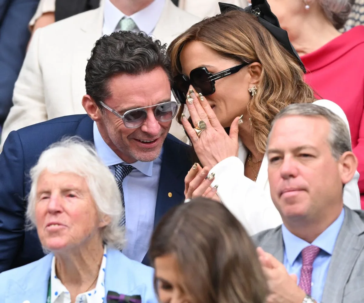 Kate was seen whispering into Hugh's ear during the match.