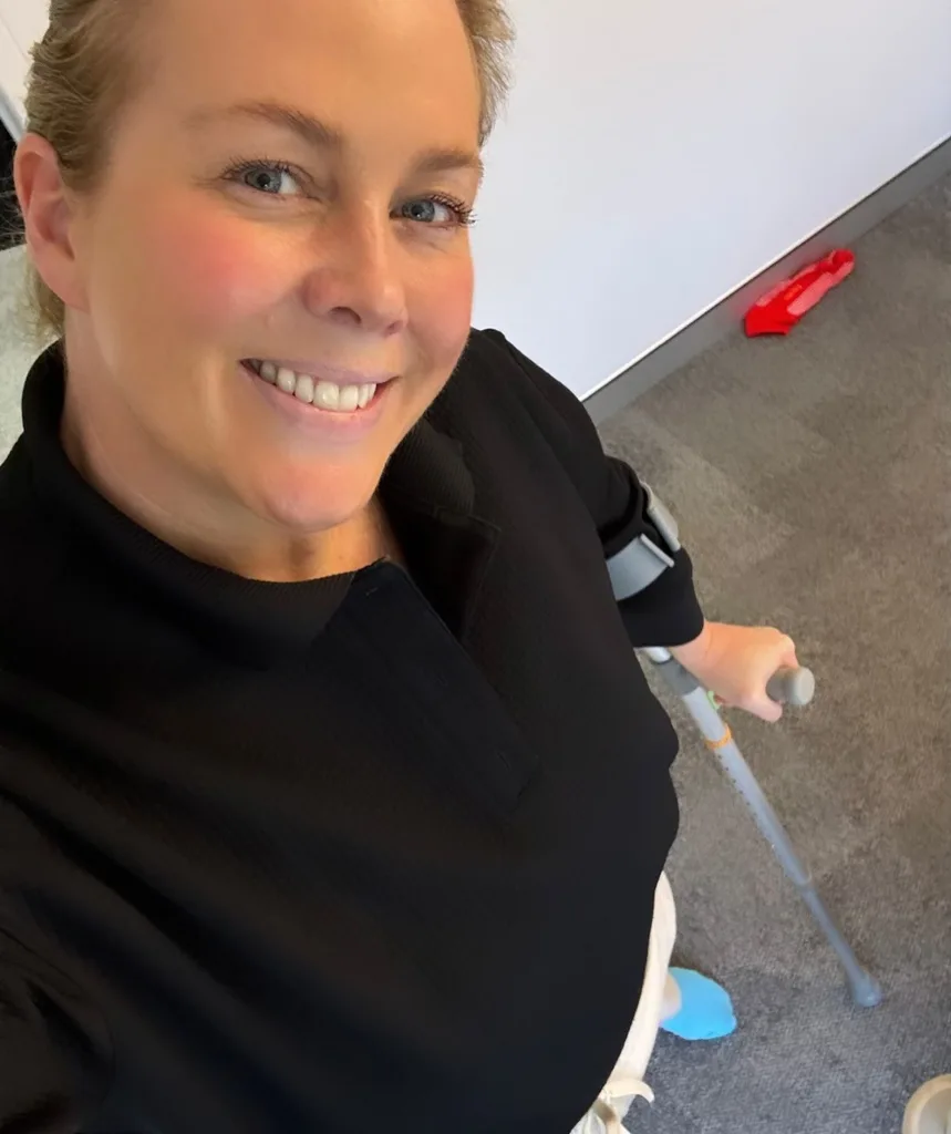 Samantha Armytage walking on crutches following surgery