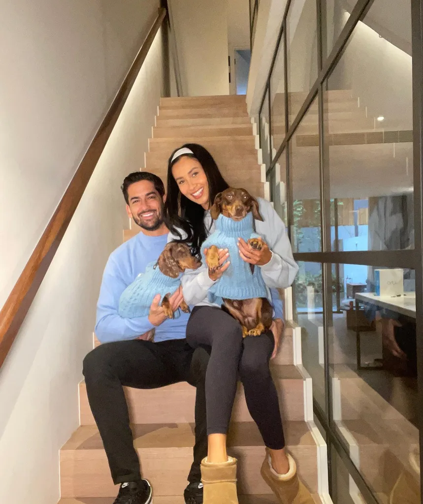 Evelyn, Duncan and the two dogs in matching blue sweaters.