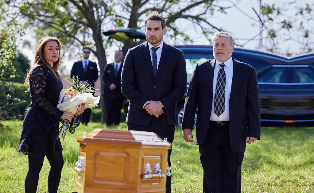 Eden, Cash and his father Gary stand in front of the coffin at Felicity's funeral