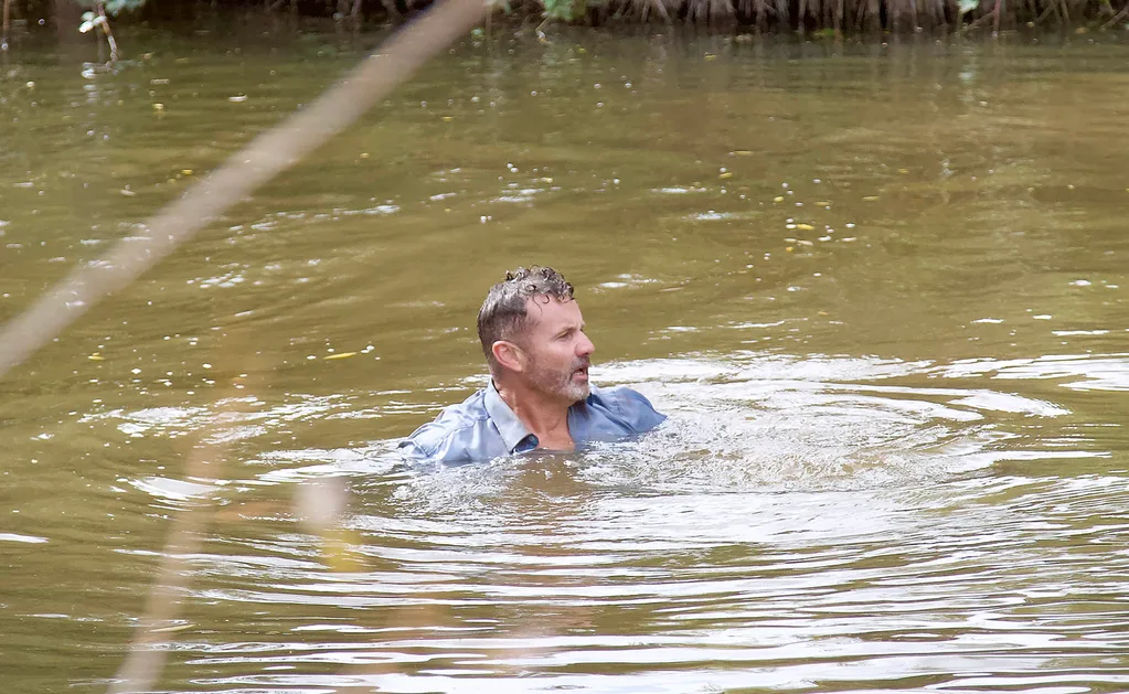 Toadie (Ryan Moloney) tries to swim through a river.