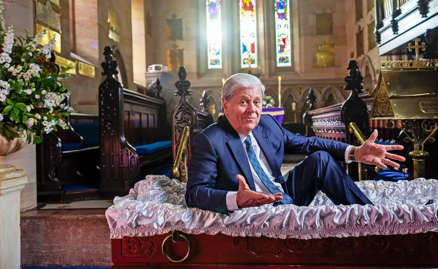 Ray Martin sits in a coffin to promote his new show Ray Martin: The Last Goodbye