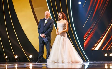 Ray Meagher and Kate Ritchie stand on the stand at the Logie Awards 2024 to present the Bert Newton award